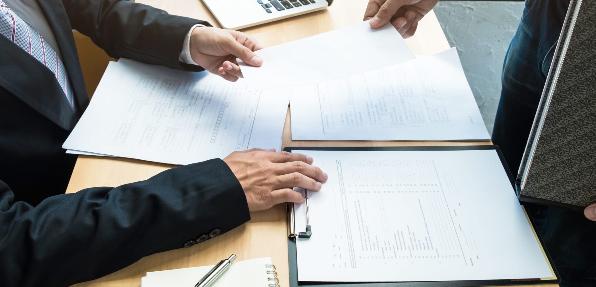 Boss received a letter of resignation from employee on the table in the office. resignation concept.